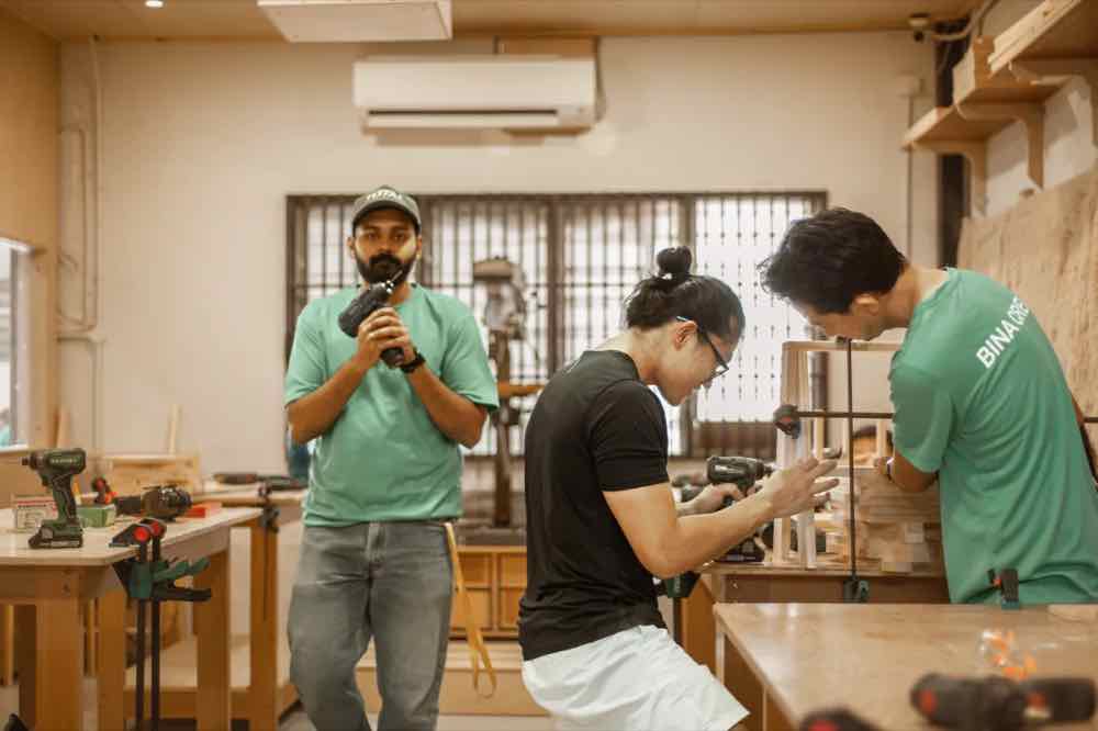 An instructor guiding trainees at the KitaBina studio