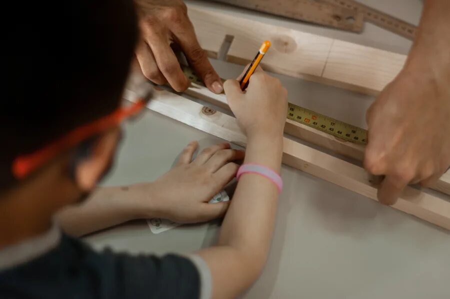 Children sawing and sanding timber at a KitaBina class