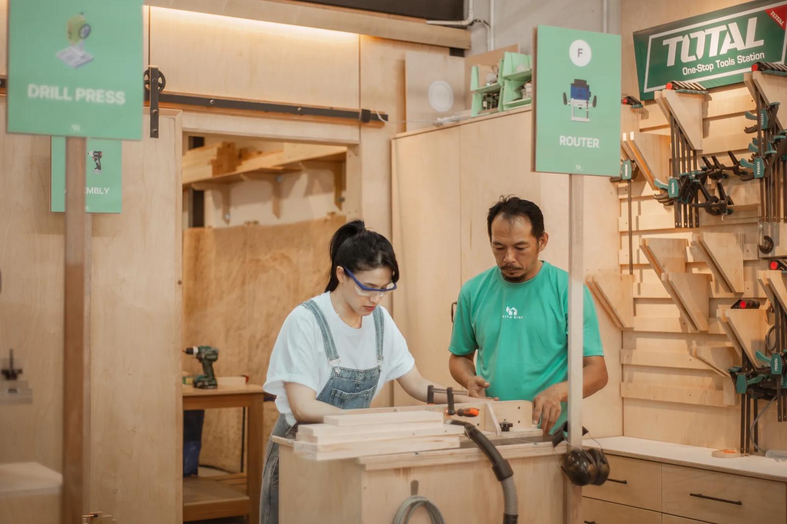 A young maker clamping timber at a KitaBina workbench