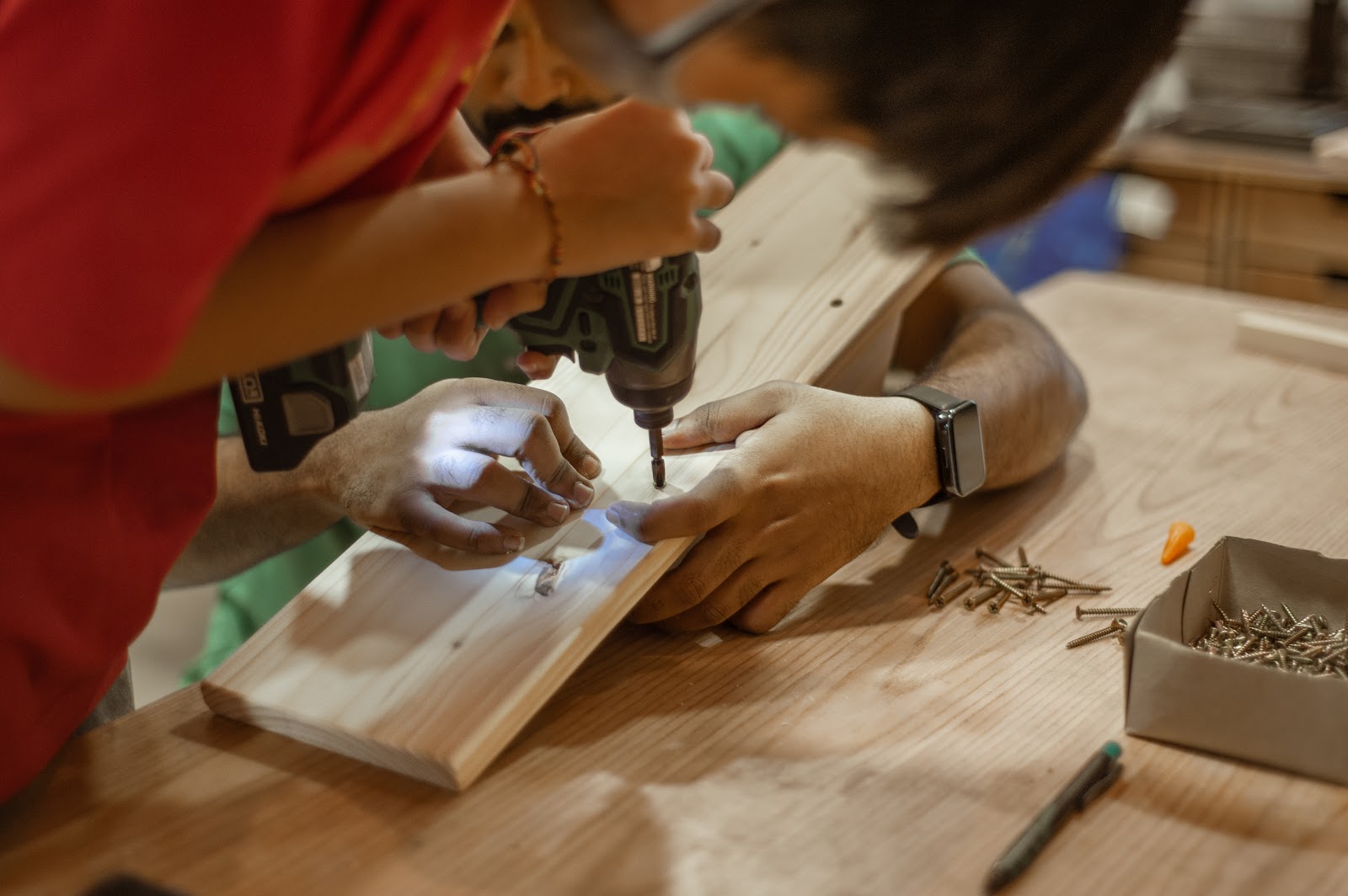 Adults learning home-repair skills at KitaBina